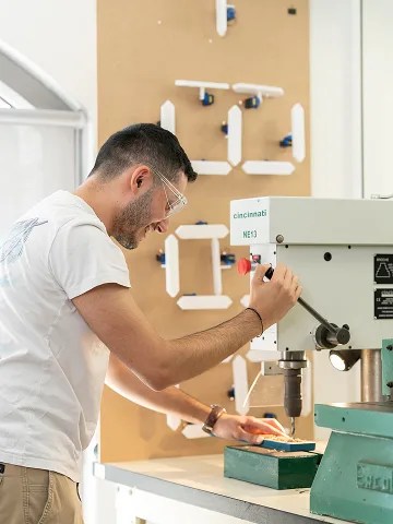 ECE student operating a pillar drill in the FabLab on the Paris campus.