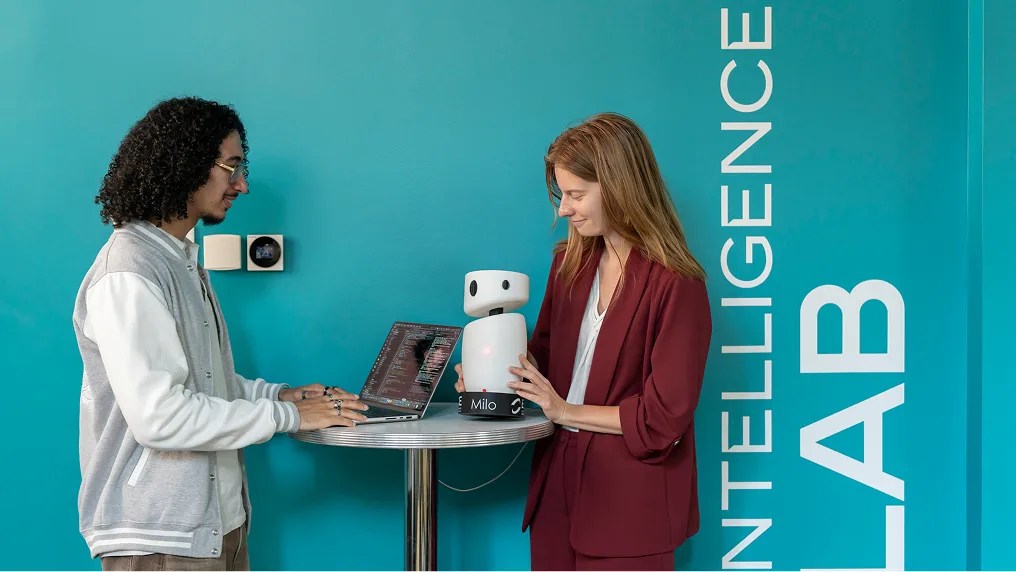 Deux étudiants programment le robot Milo sur un ordinateur portable dans l'Intelligence Lab de l'ECE.
